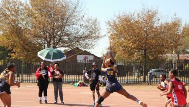 A Midrand Royals Netball Club U19 player catches the ball.