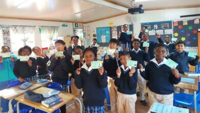 Summerhill Prep learners show their voting IDs.