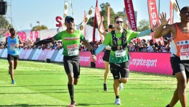 Mthokozisi Twala and Mike Esterhuysen of Midrand Striders approach the 2024 Comrades Marathon finish line.