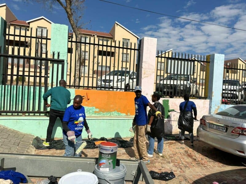Armed with gloves, weed-eaters, paint brushes, and hacksaws, the group dedicated their time to tidying the area and giving the Angel Tots Academy a fresh coat of paint.