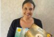 Carla De Gouveia poses for a picture with four of her released books. Photo: Supplied