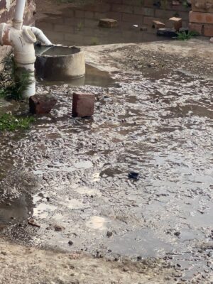 The resident’s blocked sewage drain overflows into her yard. Photo: Zanele Mfaba 
