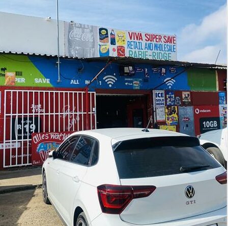 Gunfire shattered the early morning silence when a gang of about 20 heavily armed suspects allegedly descended on a local supermarket, leaving a security guard critically wounded during a robbery.