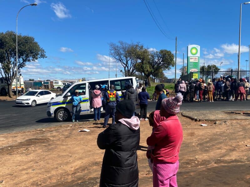 Traffic is moving again in Rabie Ridge after police intervened in a fiery early morning protest, but residents remain gathered and on edge as frustration over unsafe conditions at Dulcie September Primary School continues to boil.