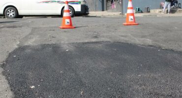 The ongoing repairs on the potholes on Market Street just outside the Boulders Taxi Rank. Photo: Zanele Mfaba