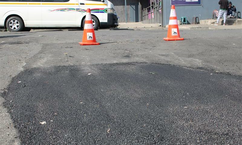The ongoing repairs on the potholes on Market Street just outside the Boulders Taxi Rank. Photo: Zanele Mfaba