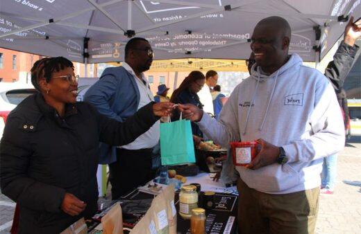 Owner of Ndyebo YeMvelo Bongiwe Mbebe, giving Urban Agriculture Manager Rodney Mudzuli some of the products he bought from Ndyebo YeMvelo at the exhibition. Photo: Zanele Mfaba