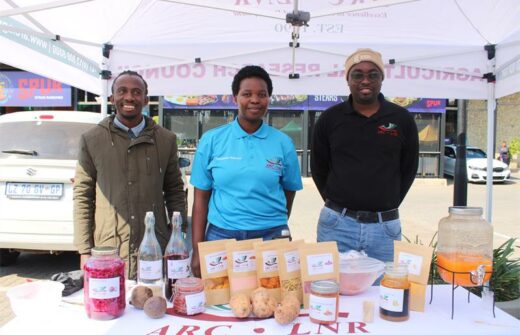 Members of the Agricultural Research Council Kevin Kutumela, Rhandzu Mahumane and Kingsly Shikwambana showcasing vegetables, vegetable juice and vegetable gummies that they produce. Photo: Zanele Mfaba