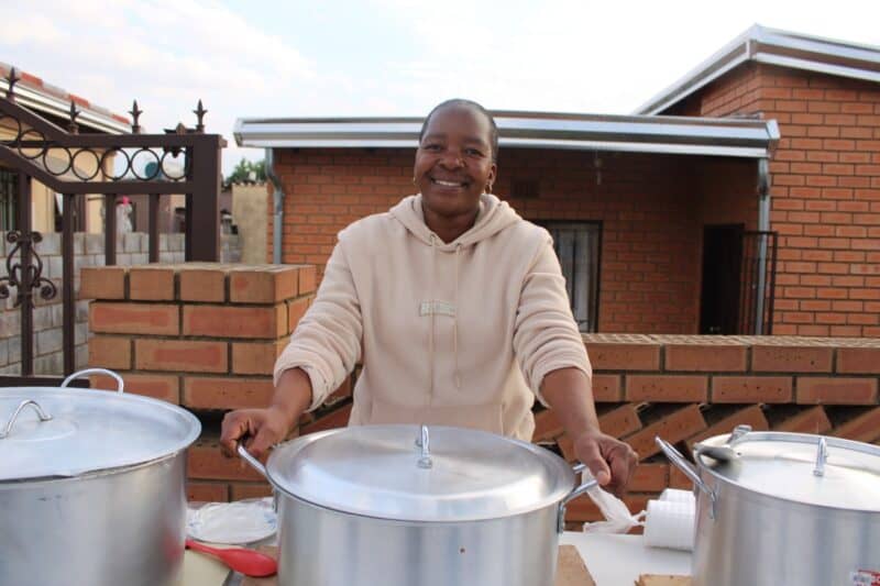 Relebohile Thapelo, a Mayibuye resident who has started an initiative of cooking for underprivileged community members, about to serve her warm home cooked meal to the community on June 19. Photo: Zanele