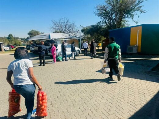 Food parcels are handed over to Noordwyk Primary School's kitchen as Joyful Giving commits to supporting the feeding scheme long-term. Photo: Supplied