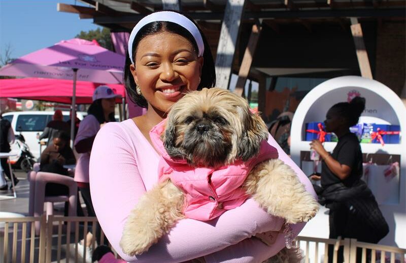 One of the attendants, Aobakwe Seepolle, holds one of the Woodrock puppies. Photo: Zanele Mfaba