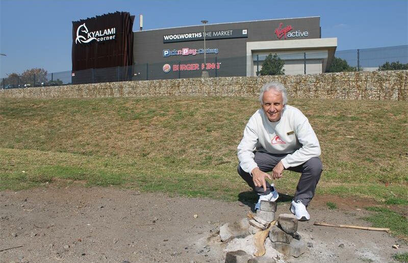 Ward 94 councillor David Foley in front of burnt items in front of the Kyalami Corner. Photo: Zanele Mfaba