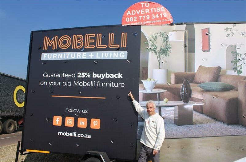 Ward 94 Councillor David Foley shows some of the illegal advertisements at the R55 and M71 intersection. Photo: Zanele Mfaba