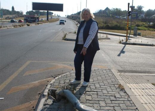 Cllr Annette Deppe shows disappointment and points at the fallen traffic light on M39 Allandale Road. Photo: Zanele Mfaba