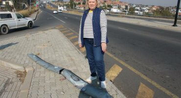 Cllr Annette Deppe shows disappointment while standing next to the fallen traffic light on M39 Allandale Road. Photo: Zanele Mfaba