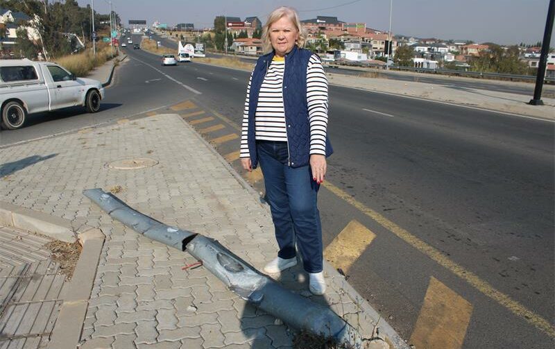 Cllr Annette Deppe shows disappointment while standing next to the fallen traffic light on M39 Allandale Road. Photo: Zanele Mfaba