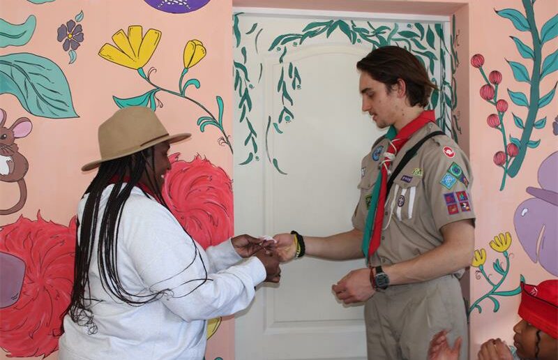 Director of New Life Centre for Girls, Khopotso "Mama K" Nakin is handed the keys to the library by young David Robson. Photo: Zanele Mfaba