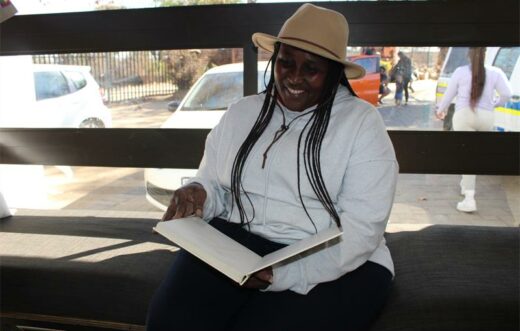 Khopotso "Mama K" Nakin sits inside the library at the centre. Photo: Zanele Mfaba
