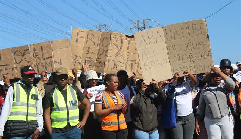 Residents display placards calling for local employment opportunities as they march peacefully to Midrand Industrial Park on June 29, 2026. Photo: Comfort Makhanya