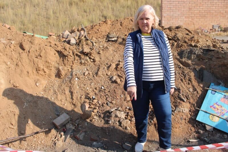 Ward 132 Cllr. Annette Deppe stands inside the dug-up hole and incomplete stormwater repair on Maple Drive on June 26. Photo: Zanele Mfaba