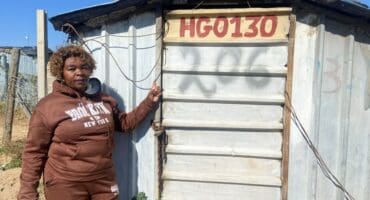Annikie Mothibi stands next to the zozo structure she alleges was moved from her original stand to another section of the Harry Gwala informal settlement while she was recovering in hospital on July 2. Photo: Comfort Makhanya