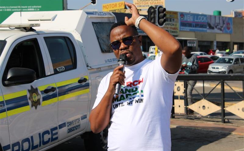 Region A March and March coordinator and convener Thabiso Gerald Mehlape, addresses the protesters and the community members before the march begins to Midrand High. Photo: Zanele Mfaba