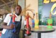Colleen Maswanganyi next to his artwork station with artworks called the First Ladies, Lady in Jazz, and Closer to my heart. Photo: Zanele Mfaba
