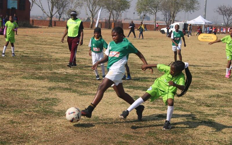 Young footballers battle for possession during the Region A girls’ football tournament at Rabie Ridge Stadium on August 8. Photo: Comfort Makhanya