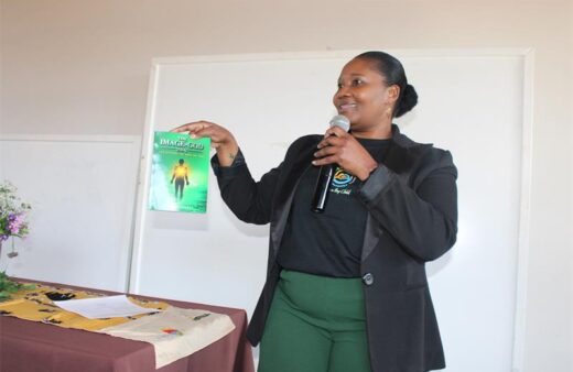 The founder of Phethahatso Foundation, Tebello Mosese, at the Moms and Sons dialogue event, presents the book to the audience, explaining how reading the book can bring them closer to God, especially the
