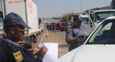 Police officers stop a motorist during the Operation Basadi roadblock on Olifantsfontein Road in Midrand on August 19, 2026. Photo: Comfort Makhanya