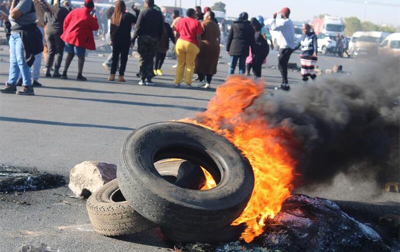 Burning tyres block roads in Commercia Extension 9 as Friendship Town Estate residents protest against a prolonged power outage and water problems on September 3. Photo: Comfort Makhanya