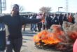 A Friendship Town Estate resident stands next to a burning tyre during a protest over prolonged electricity and water outages in Commercia Extension 9 on September 3. Photo: Comfort Makhanya