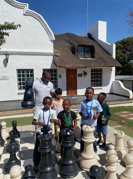Midrand Chess Club coach Kgosimang Molefe with some of the young winners from the classical tournament. Photo: Supplied