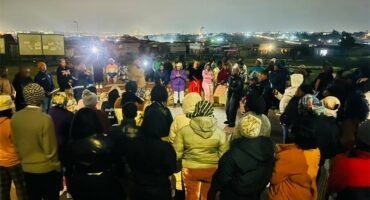 Mayibuye residents gather with candles and placards on September 18 to honour women who lost their lives to gender-based violence and femicide. Photo: Comfort Makhanya