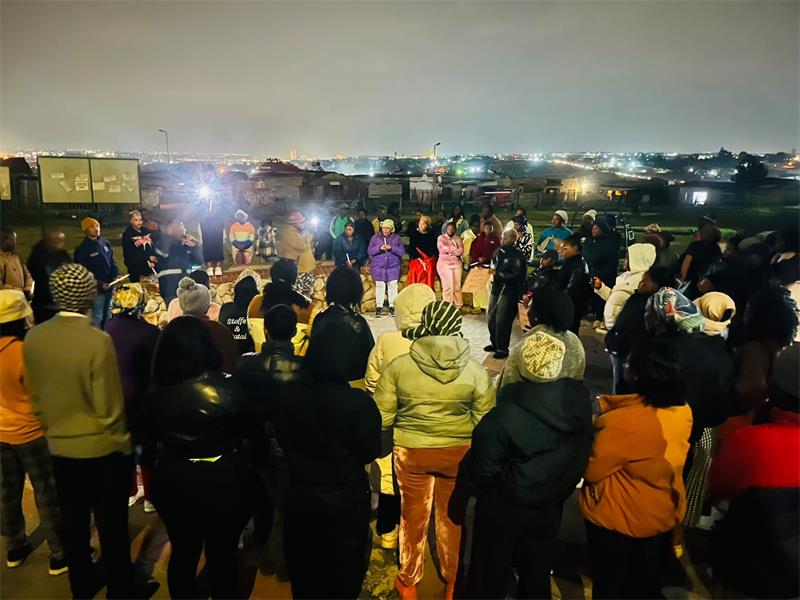 Mayibuye residents gather with candles and placards on September 18 to honour women who lost their lives to gender-based violence and femicide. Photo: Comfort Makhanya