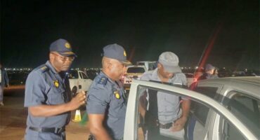 Law-enforcement officers inspect vehicles during the Operation Shanela 2 crackdown in Clayville on September 26. Photo: SAPS