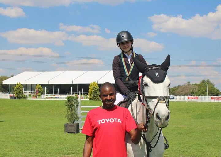 Description: Ela Vita Kastelic, Callaho Valencia and Julius Chifwede after coming second on her debut at Kyalami Equestrian Park on October 3, 2026. Photo: Itumeleng Molefe