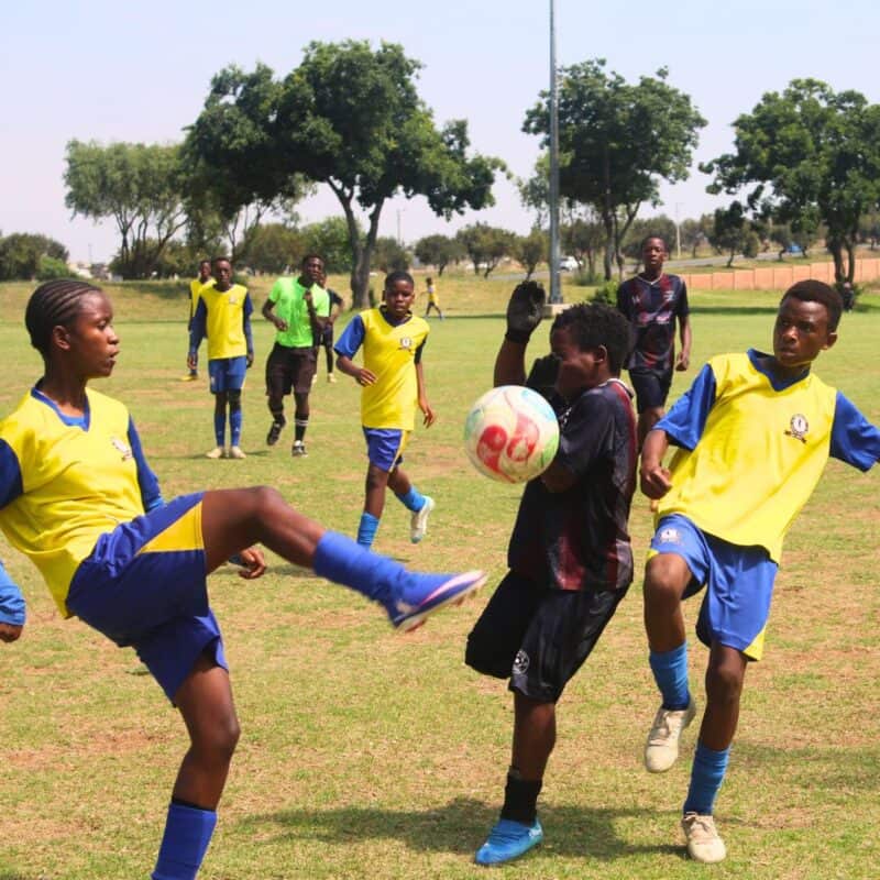 Njabulo Nhlengethwa of Phomolong United (centre) fights for an aerial ball against Nkulisa FC’s Sbongumusa Mpofu and Rokunda Mandlwana during their Midrand U15 League encounter at Rabie Ridge Stadium on October 10. Photo: Comfort Makhanya
