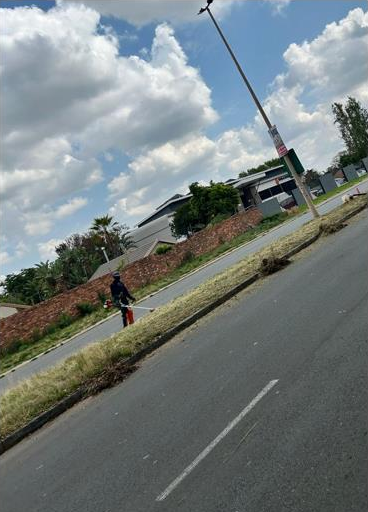 Grass is trimmed along Janadel Avenue after Emeris Waterfall staff completed their World Clean-up Day clean-up. Photo: Supplied