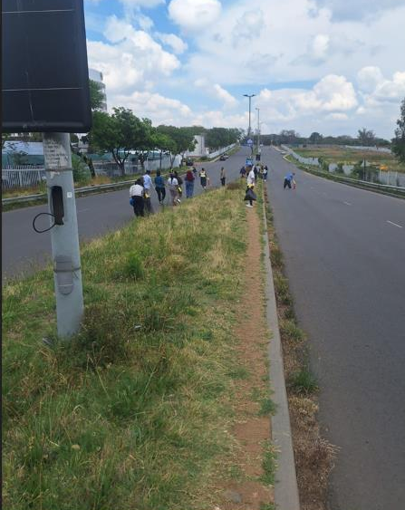 Emeris Waterfall staff roll up their sleeves as they clean Janadel Avenue in Midrand during World Clean-up Day. Photo: Supplied