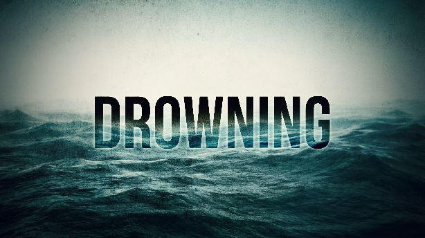 A dark themed picture of water with DROWNING written in bold black text.