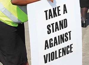 Image of a person holding an anti GBV poster.