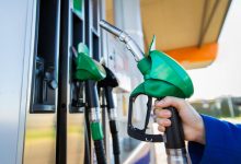 Image of a hand holding a petrol pump.