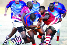 Image of Sentraal Rugby Club in action against opponents with the Sentraal player charging forward with the ball.