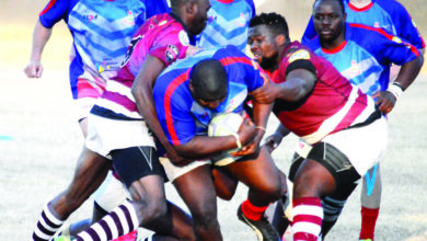 Image of Sentraal Rugby Club in action against opponents with the Sentraal player charging forward with the ball.