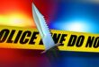 A blood-stained knife and yellow police tape, symbolising a crime scene under active investigation.