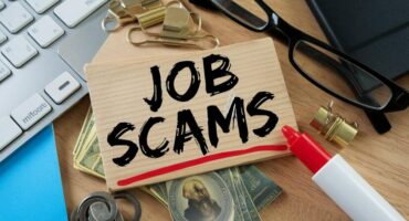 Job scams underlined in red highlighter, with glasses and paper clips around it.