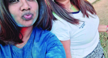 Image of two ladies at the Glencoe Holi festival with face paint.