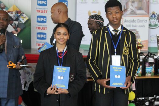 Two young authors show off their collaborative book during the launch.