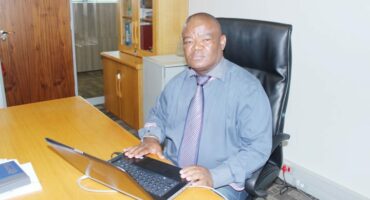 Newcastle Acting Municipal Manager, Dr Dumisani Thabethe behind his desk.